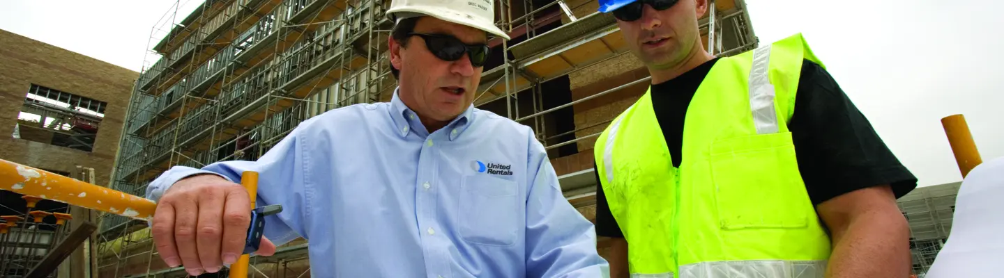 two men in hard hats on construction site