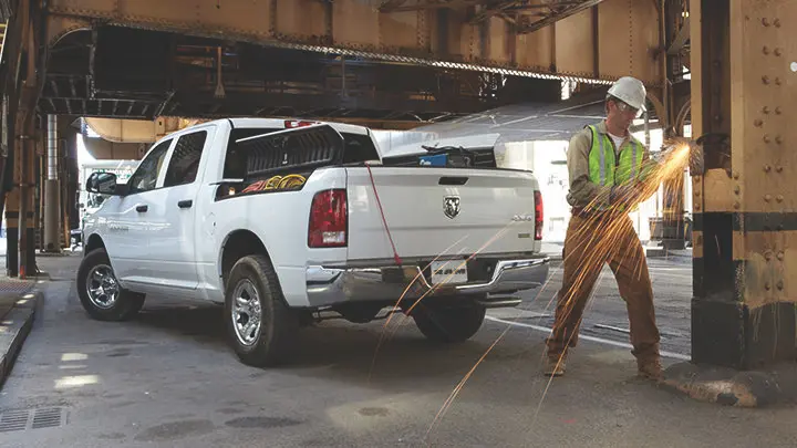 welder working in front of white truck