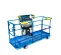 Front angled view of a blue and yellow aerial work platform with guardrails and a control panel.