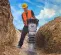 Yellow and silver Wacker-Neuson heavy-duty vibratory rammer being used to tamper soil