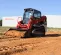 Red and black Takeuchi Compact Track Loader
