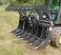 Gray Paladin Root Grapple Bucket Attachment on a Skid Steer