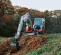 Red and white Takeuchi Mini Excavator with Reduced Tail Swing