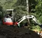 Red, white and gray TAKEUCHI 3,000-3,999 lb. Mini Excavator, Zero Tail Swing