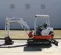 White, red and gray TAKEUCHI 4,000-5,000 lb. Mini Excavator, Zero Tail Swing