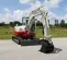 White, red and gray TAKEUCHI 10,000-12,000 lb. Mini Excavator