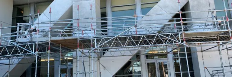 scaffolding in front of steps outside of an office building