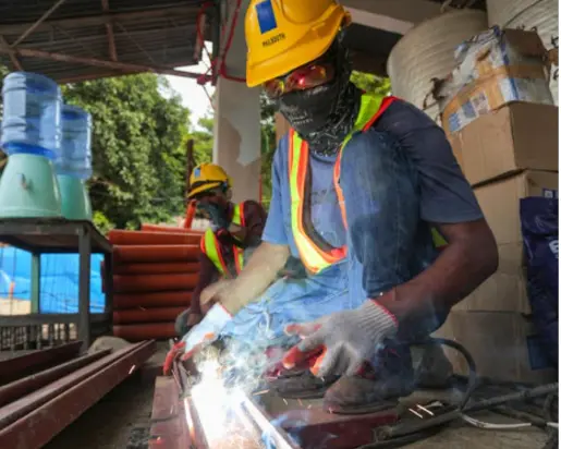 Worker in PPE working with sparks