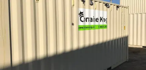 beige shipping container under blue sky