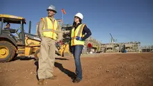 man and woman on jobsite in ppe