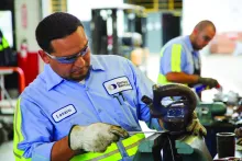 2 men working in shop on equipment