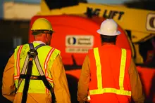 two men on jobsite wearing ppe