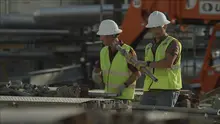 two men in hard hats on construction site
