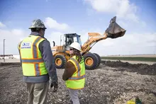 two men in hard hats on construction site