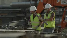 two men on jobsite in hardhats