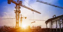 sun coming up over construction site