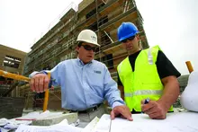two men walking in ppe on construction site