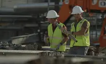 two men walking in ppe on construction site
