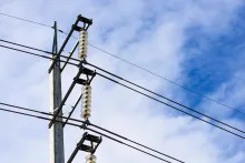 electricity post against blue sky