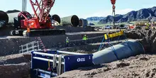 Trench safety workers in trench on large pipe