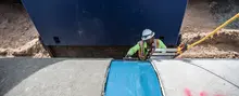 Worker in a trench wearing PPE